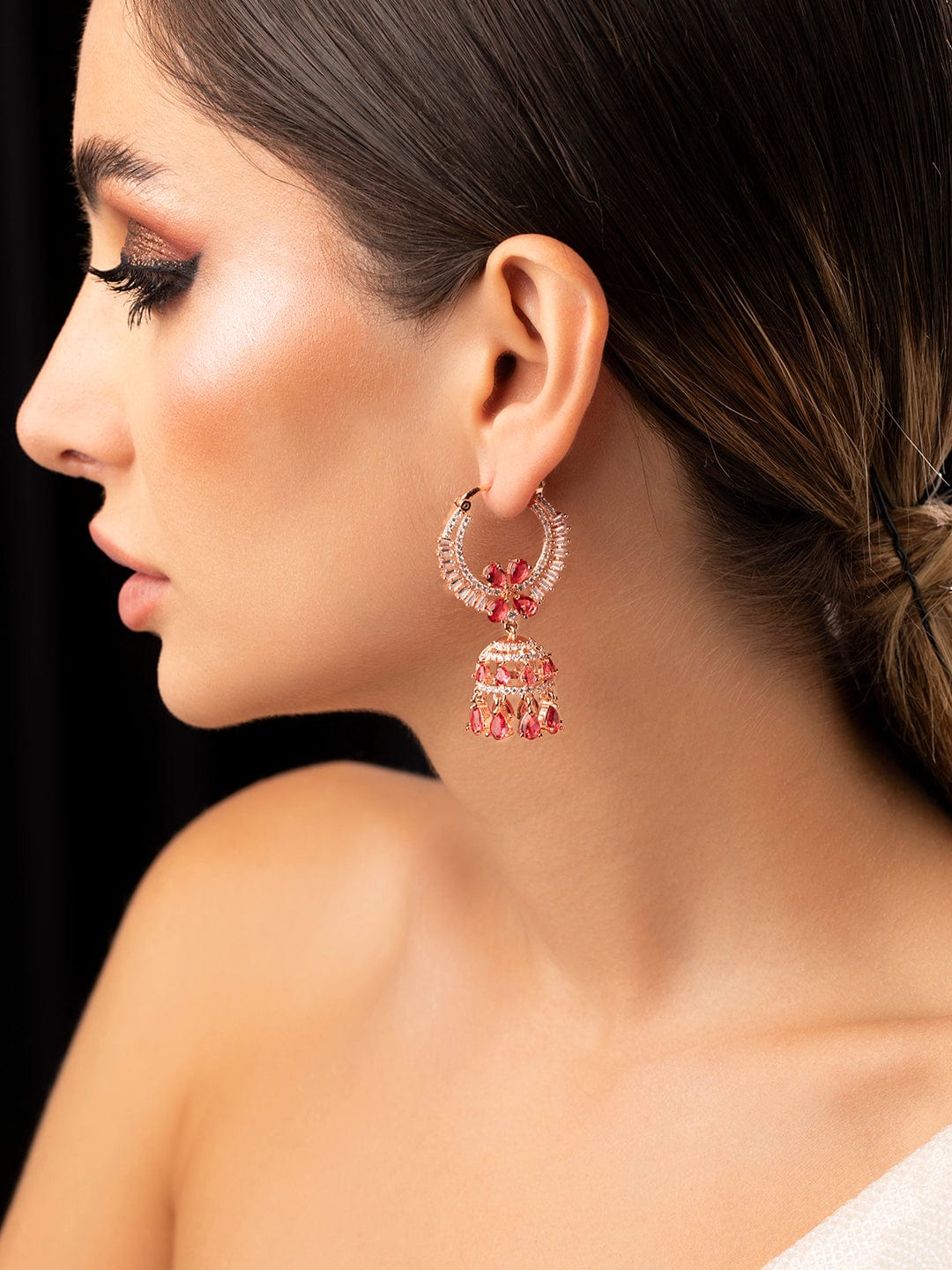 Young beautiful African lady wearing fashionable traditional pink dress and  head scarf, earrings and makeup, sitting on the bed in studio and looking  away Stock Photo - Alamy