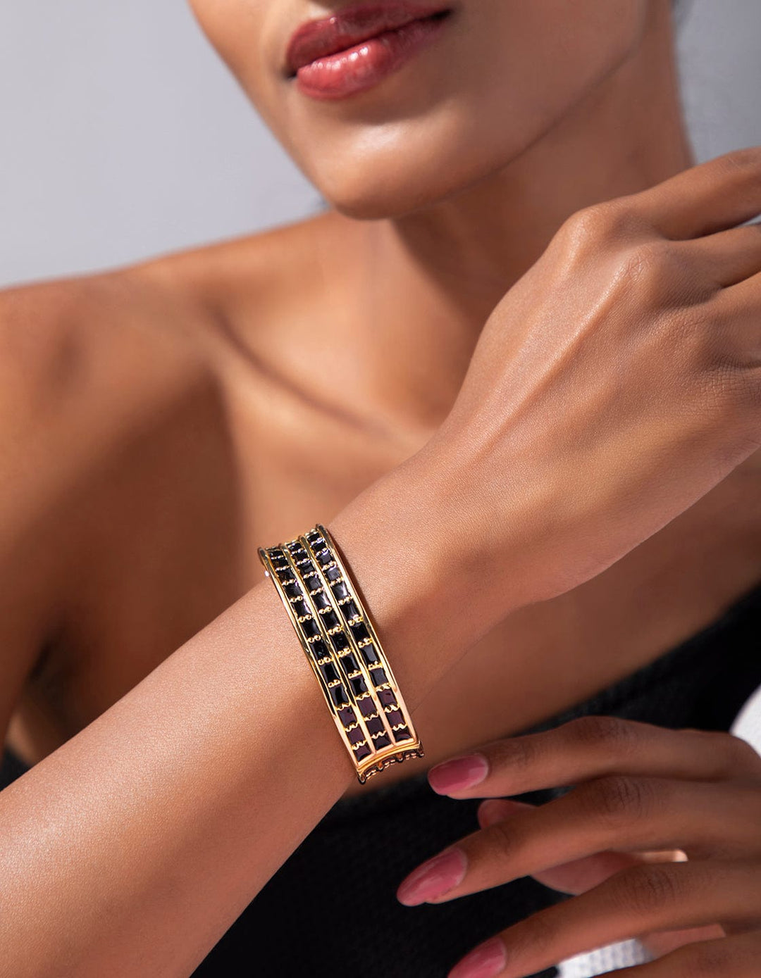 Rubans Voguish gold plated broad black bracelet with gold tone studded stones. Bangles & Bracelets